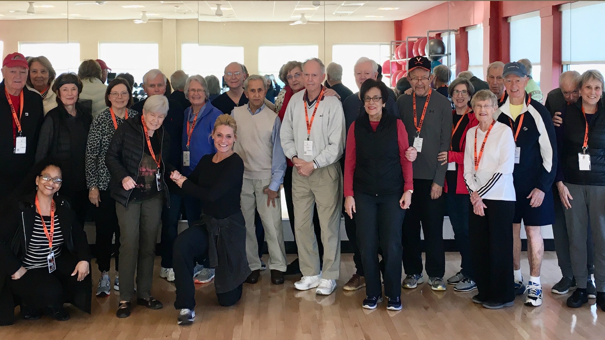 a group of people posing for a photo in a gym.