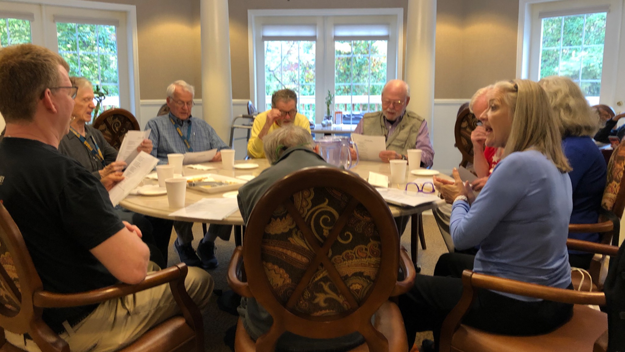 a group of people sitting around a table.