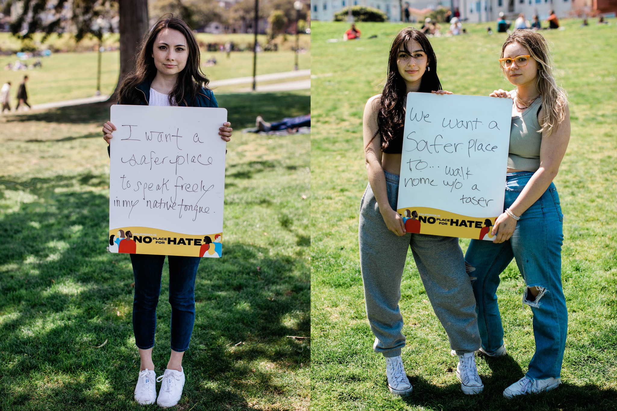 two women holding signs in a park.