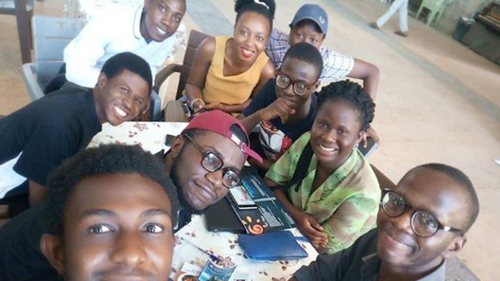 a group of people posing for a picture at a table.