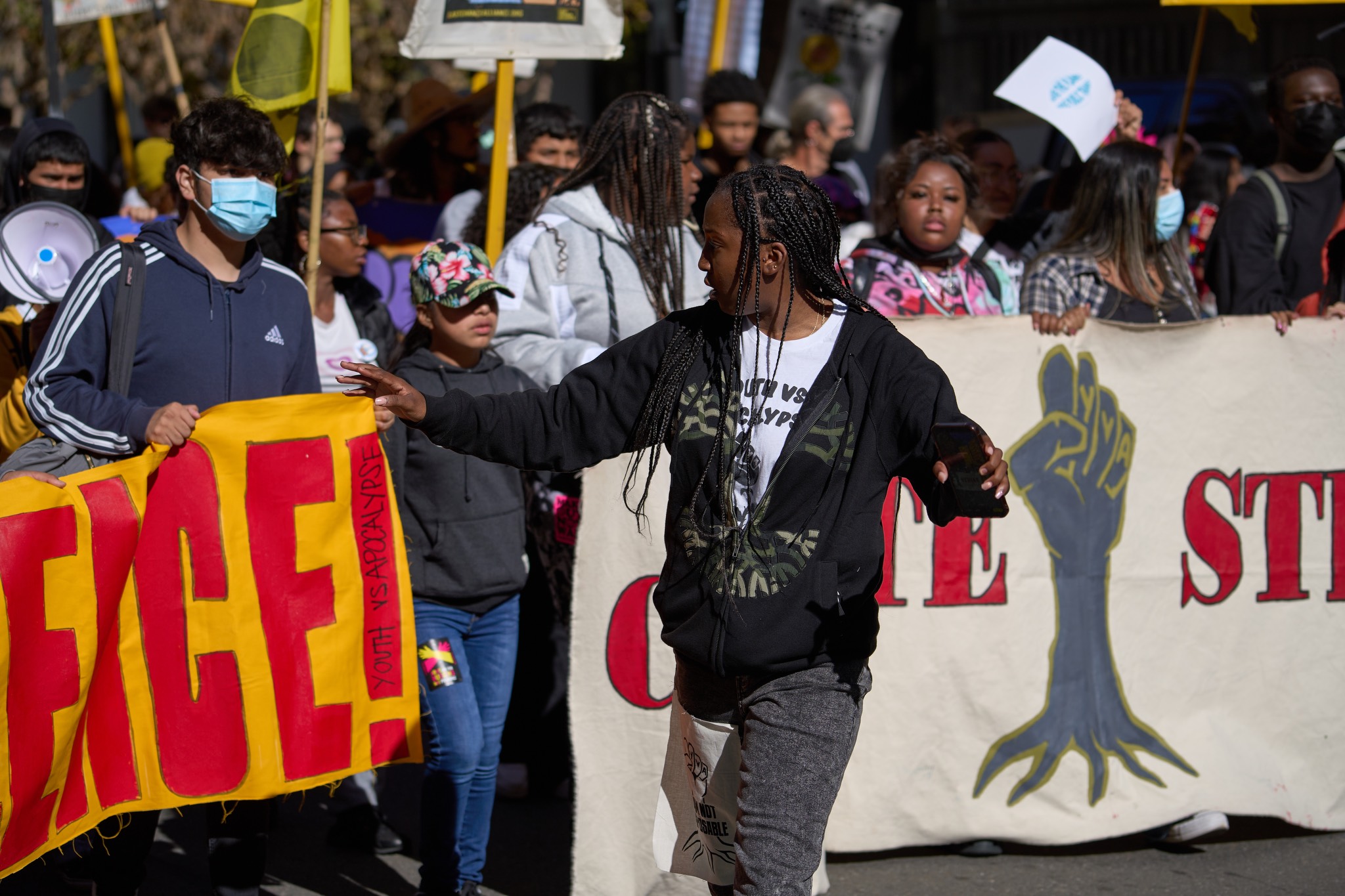 a group of people holding signs in front of a crowd.