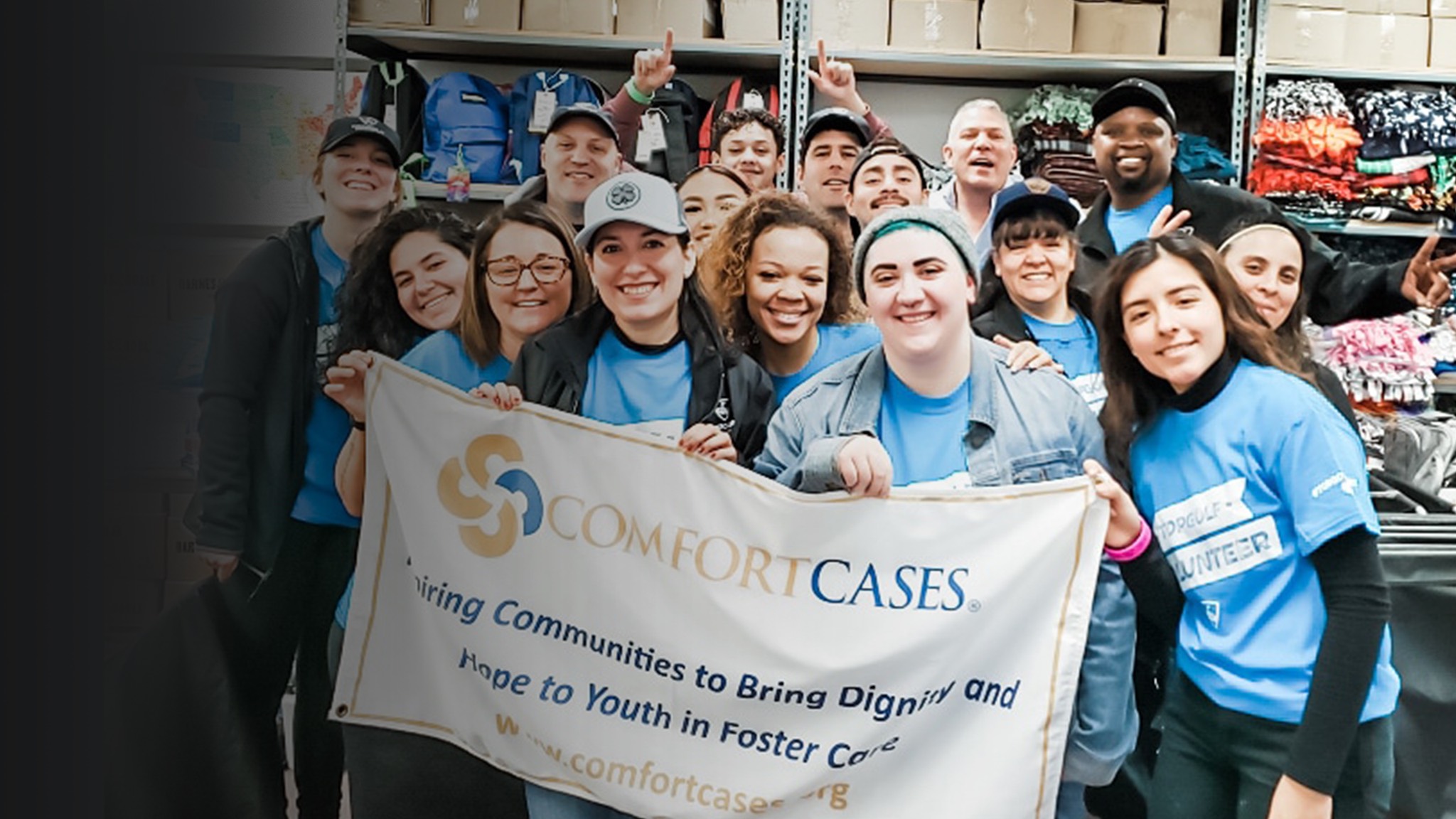 a group of people in blue shirts holding a banner that says comfort cakes.