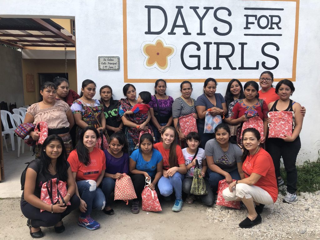 a group of women posing in front of a sign that says days for girls.