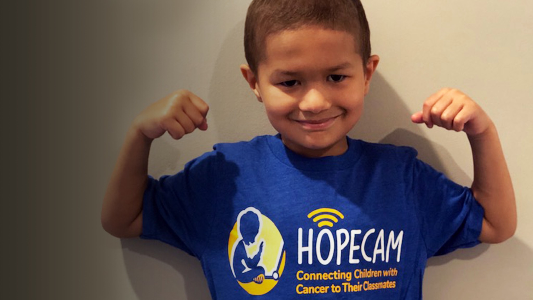 a boy with a t - shirt that says hopecam.