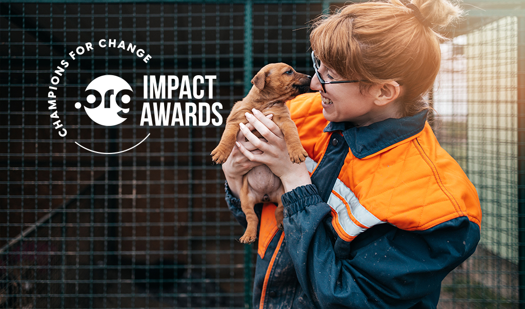 a woman holding a dog with the words impact awards.