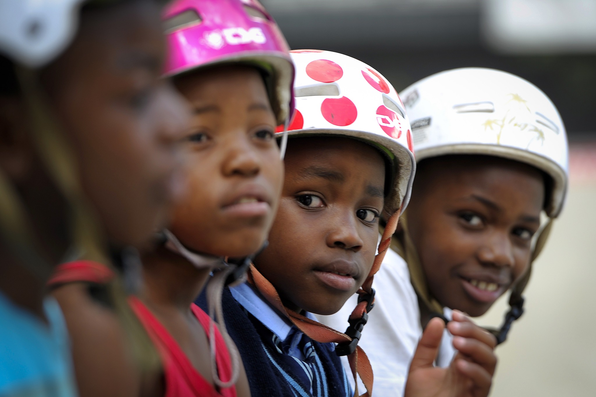 a group of kids wearing helmets.