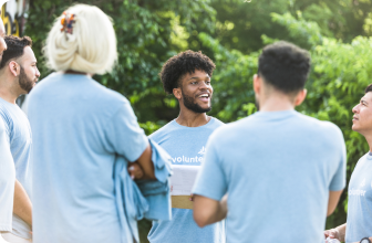 a group of people in blue t - shirts talking to each other.